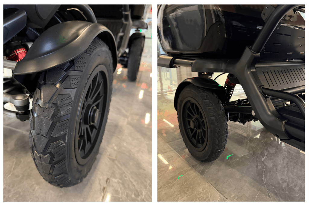 Close-up of a black motorcycle front wheel and fender, with a red spring shock visible.