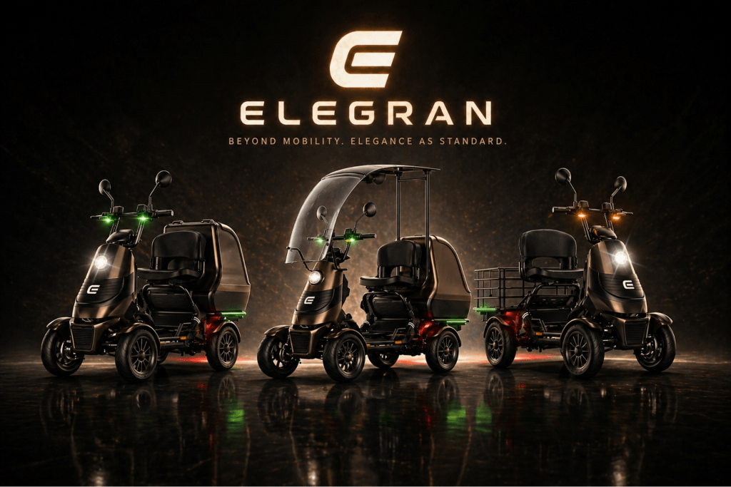 Four Elegran mobility scooters lined up on a dark, glossy surface with a large Elegran logo above them in a warm glow.