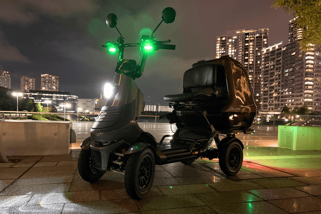 Three-wheeled urban scooter with bright green lights, parked on a wet rooftop at night with a city skyline in the background.